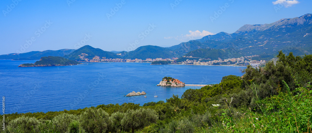Sveti Stefan, a medieval village located on a small island connected to the mainland by a narrow tombolo (sandy isthmus) in the bay of Budva along the Adriatic Coast, Montenegro