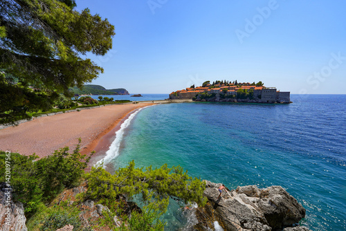 Obraz na płótnie Beach of Sveti Stefan, a medieval village located on a small island connected to the mainland by a narrow tombolo (sandy isthmus) in the bay of Budva along the Adriatic Coast, Montenegro w salonie