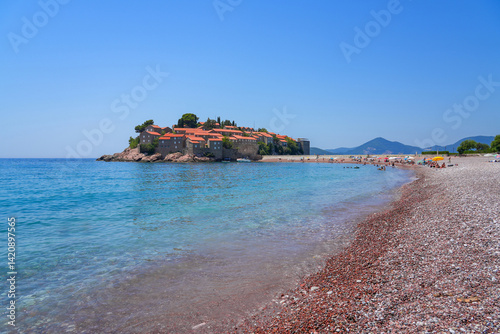 Obraz na płótnie Beach of Sveti Stefan, a medieval village located on a small island connected to the mainland by a narrow tombolo (sandy isthmus) in the bay of Budva along the Adriatic Coast, Montenegro w salonie