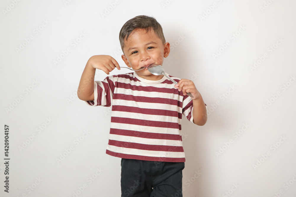 Naklejka premium Front view of a cute asian boy ready to eat with isolated white background.