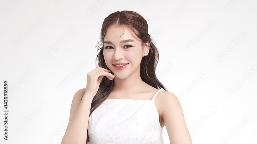 A beautiful young Asian woman with clean, fresh skin against a white background. Skincare, facial treatment, cosmetology, beauty, and spa. An elegant portrait of an Asian woman. A beautiful young Asian woman with clean, fresh skin against a white background. Skincare, facial treatment, cosmetology, beauty, and spa. An elegant portrait of an Asian woman.