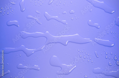 Drops of water on purple background.