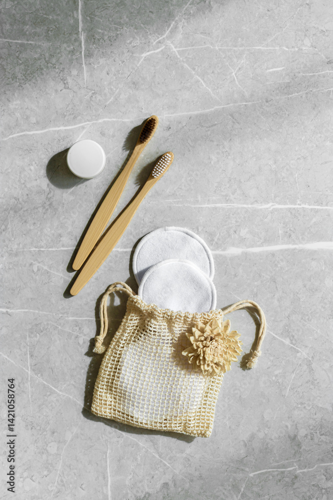 Minimal aesthetic lifestyle with Eco-Friendly Personal Care Product, bamboo toothbrushes, Natural Oral Care Products, wooden comb, reusable pads, shadows at sunlight. Top view bathroom essentials