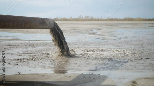 Pollution of the environment by industrial outfalls. Flow of dirty water flows out of the pipe.