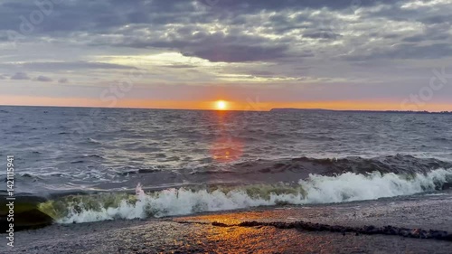 Sunset Sky with Clouds Reflected on Water Surface