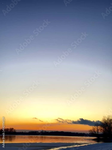 Sunset Sky with Clouds Reflected on Water Surface