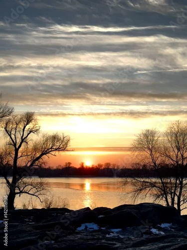 Sunset Sky with Clouds Reflected on Water Surface
