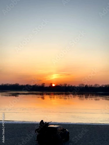 Sunset Sky with Clouds Reflected on Water Surface