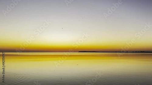 Sunset Sky with Clouds Reflected on Water Surface