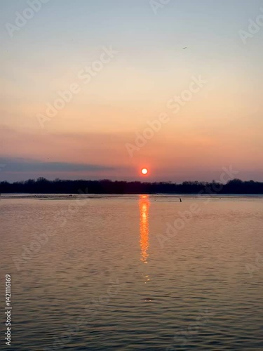 Sunset Sky with Clouds Reflected on Water Surface
