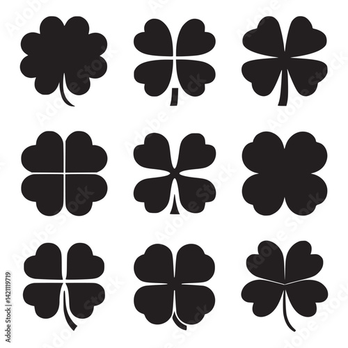A set of black leaf clover silhouettes on a white background 