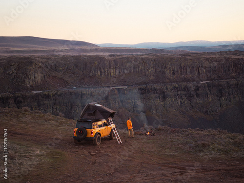 Overland truck and camper with campfire near canyon, Washington