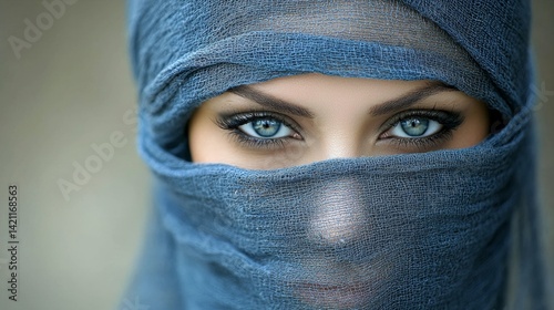 A woman with blue eyes wearing a blue veil