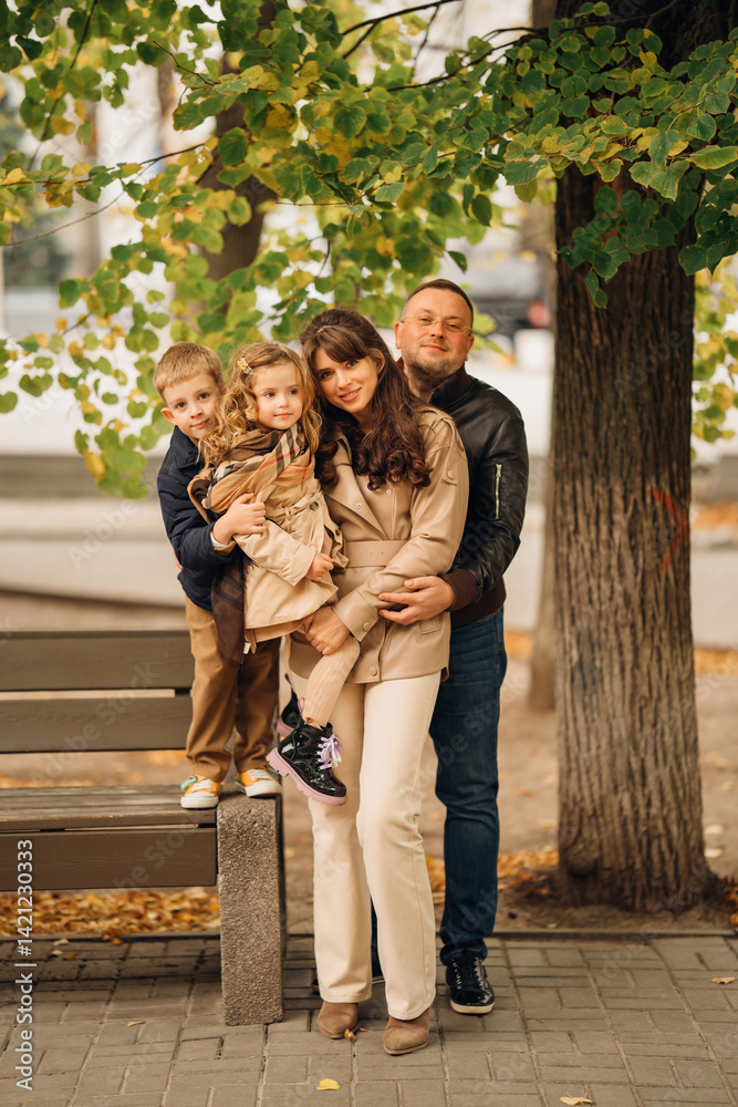Family enjoying a joyful moment in a park during autumn