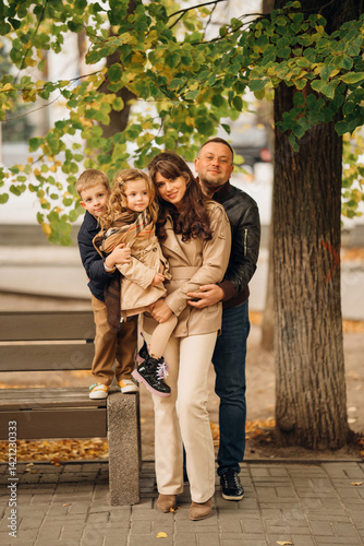 Obraz na płótnie Family enjoying a joyful moment in a park during autumn w salonie