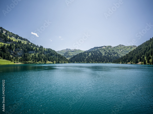 Symmetrical view of Saint-Guérin lake and mountains, French Alps