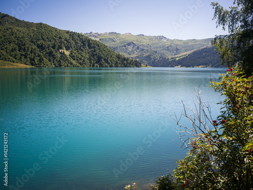 Clear turquoise water of Saint-Guérin lake on a sunny summer day, French Alps