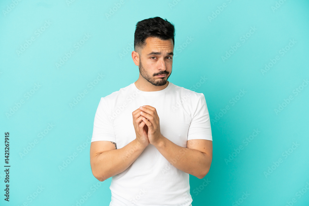 Young caucasian man isolated on blue background scheming something