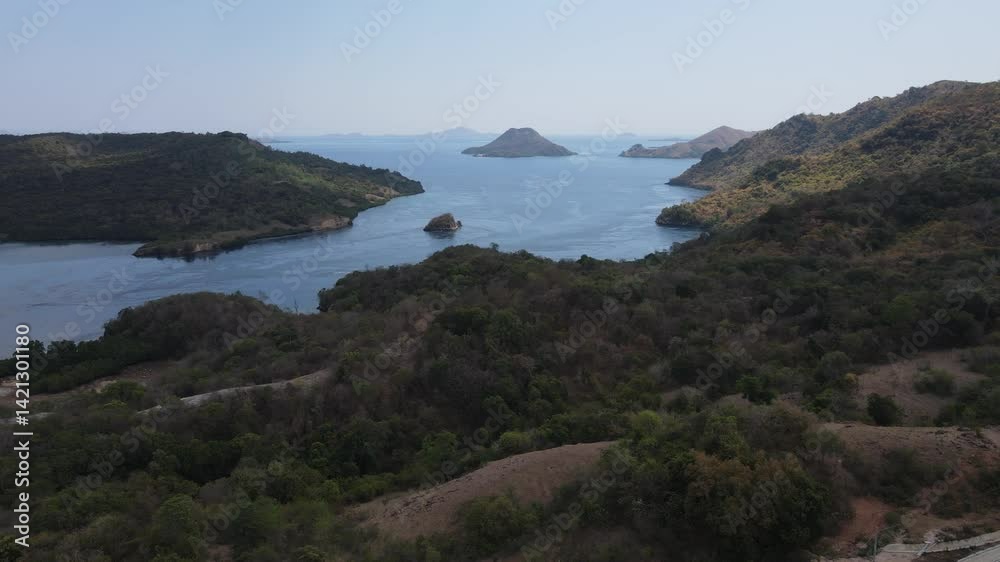Aerial drone landscape view of Golo Mori island mountain peak in Labuan Bajo, Indonesia.