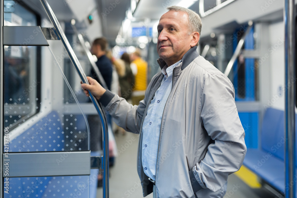 Pensioner 60 year old rides in an subway car