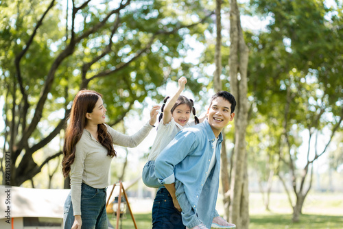 Happy asian family picnic in park, weekend lifestyle outdoors.
