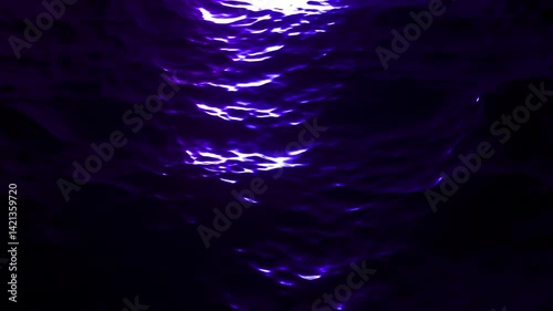 A reflection of the moon on calm ocean water in a seamless loop.

