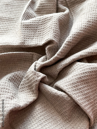 Close up of bunched up waffle weave gray throw blanket