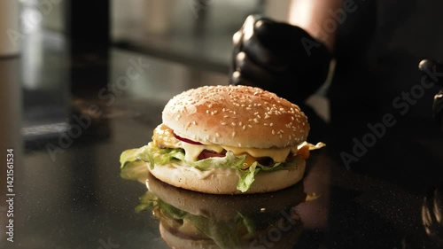 The chef's hands have prepared a burger on summer day 
