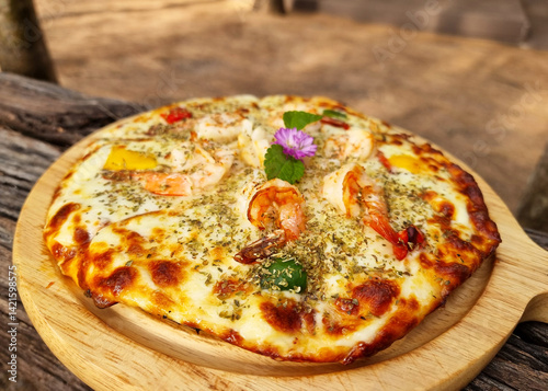 Delicious seafood cocktail pizza on the wooden plate.
