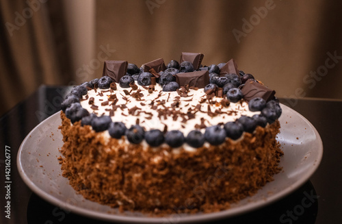 delicious chocolate cake with candles and blueberries for a holiday or birthday.