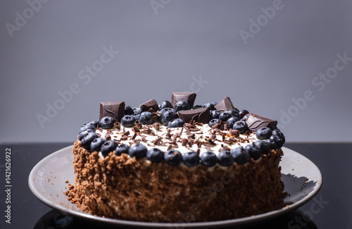 delicious chocolate cake with candles and blueberries for a holiday or birthday.