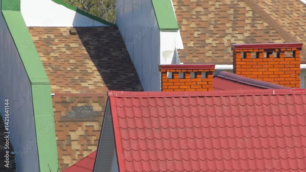 Wavy air distortion above rooftops on hot summer day. Red metal roof ...