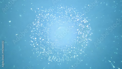 High-angle video captures an explosion of bioluminescent spores, a radiant burst of shimmering light, set against a clean, uniquely blurred pale blue background