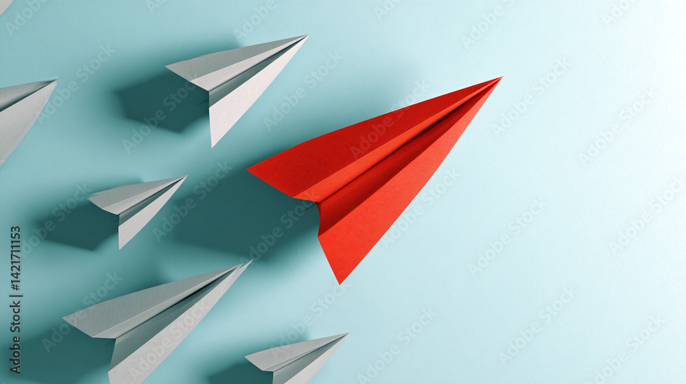 Fototapeta premium Red paper airplane leading a group of gray ones on a light-blue background, symbolizing leadership, innovation, and standing out from the crowd. Free space for text