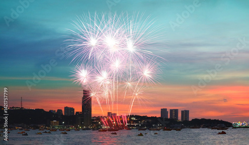 Panorama of Pattaya city and  fire work at bay on the sunset sky