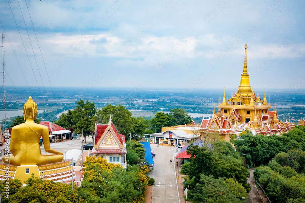 Naklejka premium Wat Khiriwong, the highlight is the Ubosot and Phra Chulamani Chedi, located on the top of Khao Daowadueng, and offers a high angle view of Nakhon Sawan. It is a beautiful sunset viewing point.