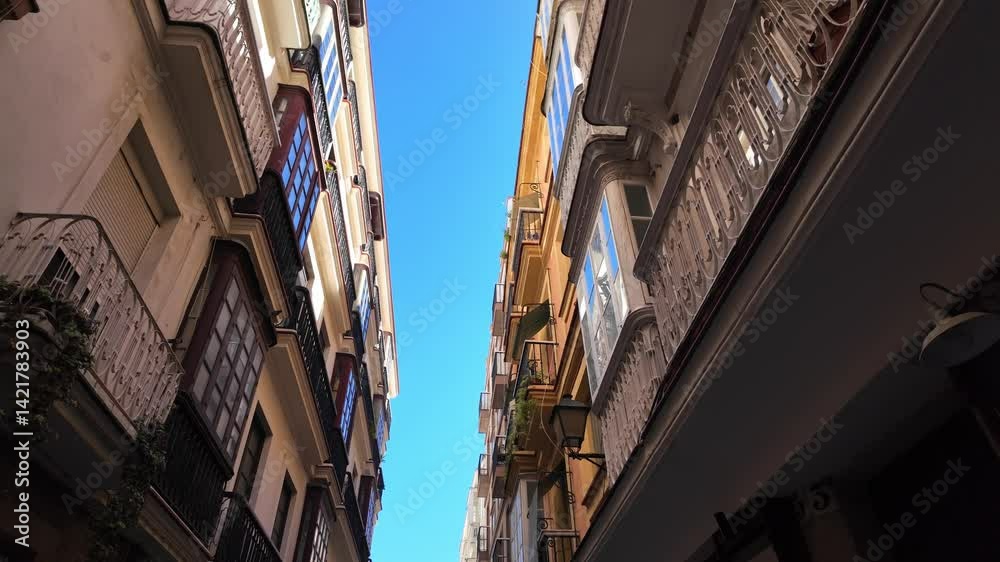 Low angle view of residential buildings in Cadiz, Spain, showing balconies and blue sky Low angle view of residential buildings in Cadiz, Spain, showing balconies and blue sky