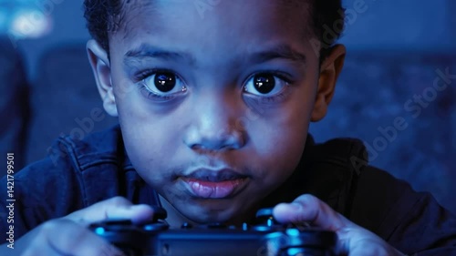 Gamer's Gaze: A focused young person engrossed in a video game, their eyes glued to the screen as they skillfully manipulate a game controller, reflecting a modern youth activity.