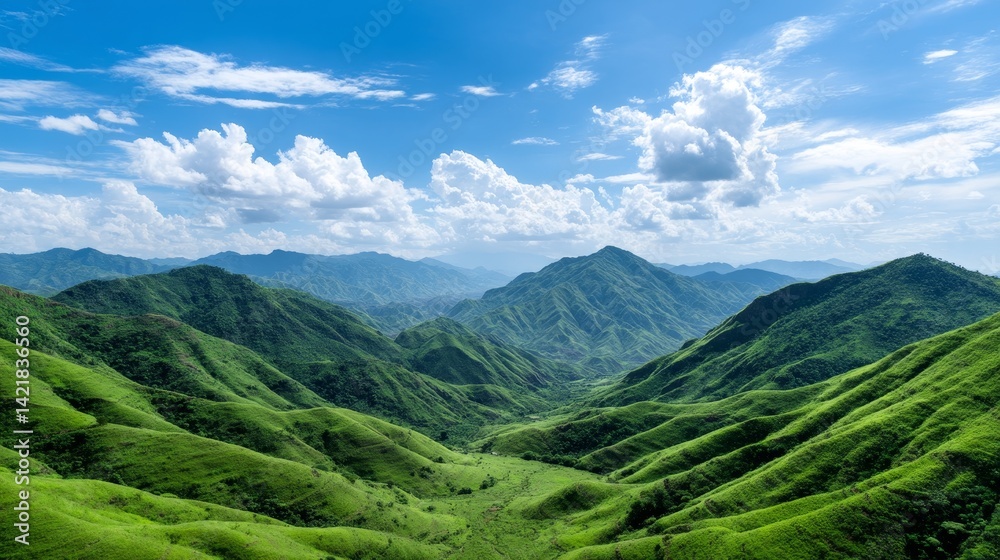 Fototapeta premium Lush Green Mountain Range Under a Clear Blue Sky - Serene landscape, rolling hills, vibrant greenery, vast expanse, peaceful nature. Symbolizing tranquility, abundance, growth, freedom, and renewal