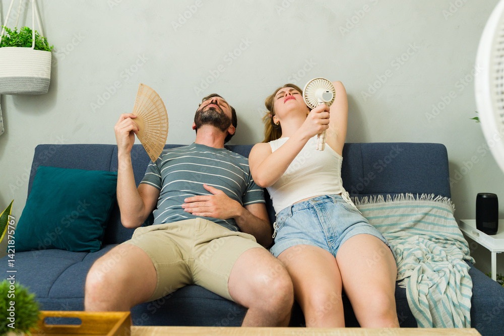Overheated couple sweating at home during summer heat wave