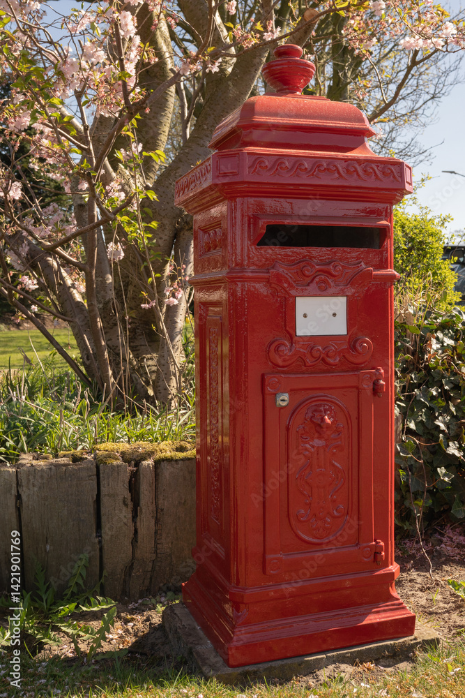 A single red mailbox in an empty street, representing the vanishing culture of personal letters and the shift to digital messaging. A single red mailbox in an empty street, representing the vanishing culture of personal letters and the shift to digital messaging.