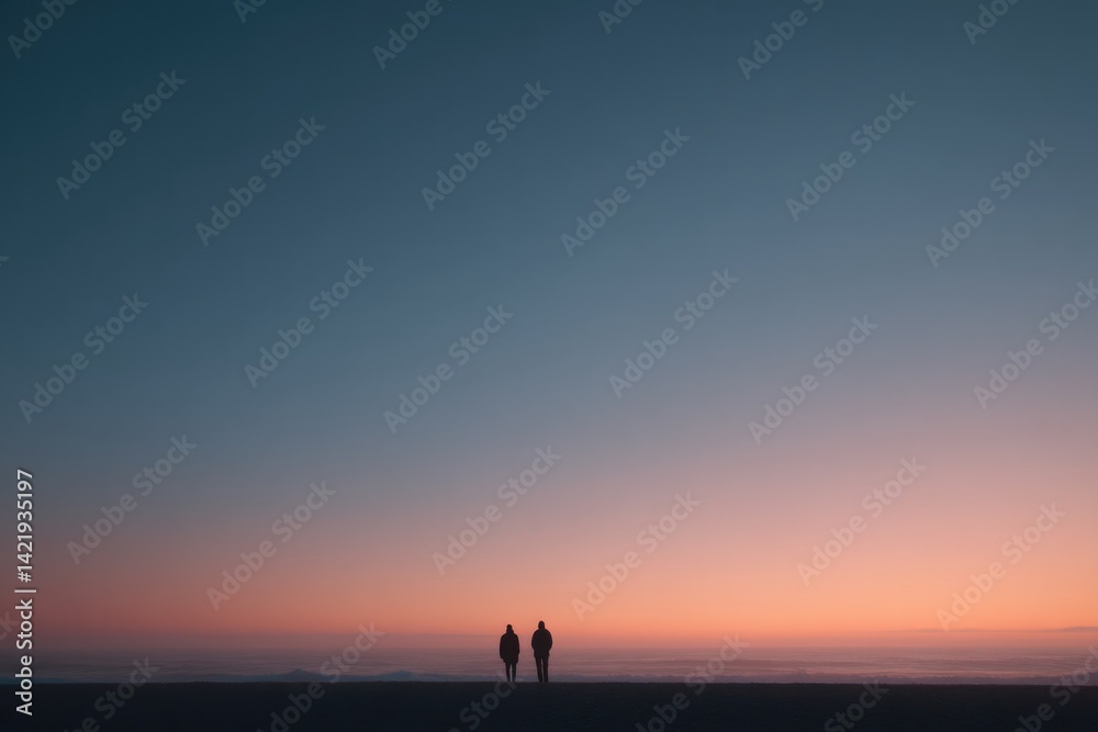 two silhouetted figures walking hand-in-hand at twilight on deserted beach with ample copy space overhead two silhouetted figures walking hand-in-hand at twilight on deserted beach with ample copy space overhead