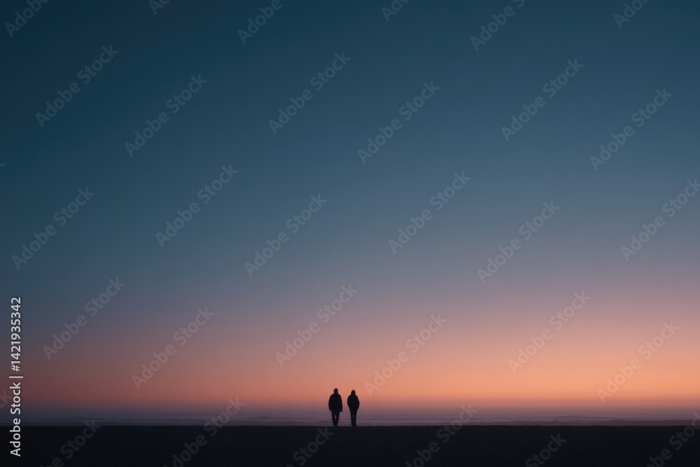 two silhouetted figures walking hand-in-hand at twilight on deserted beach with ample copy space overhead two silhouetted figures walking hand-in-hand at twilight on deserted beach with ample copy space overhead
