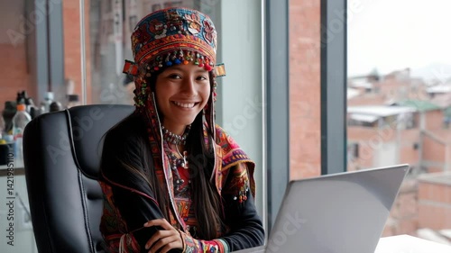 Indigenous woman in front of a laptop in an office