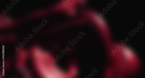Abstract dark red blurred liquid or smoke slowly swirling and evolving on a black background. Moody and mysterious animated texture
