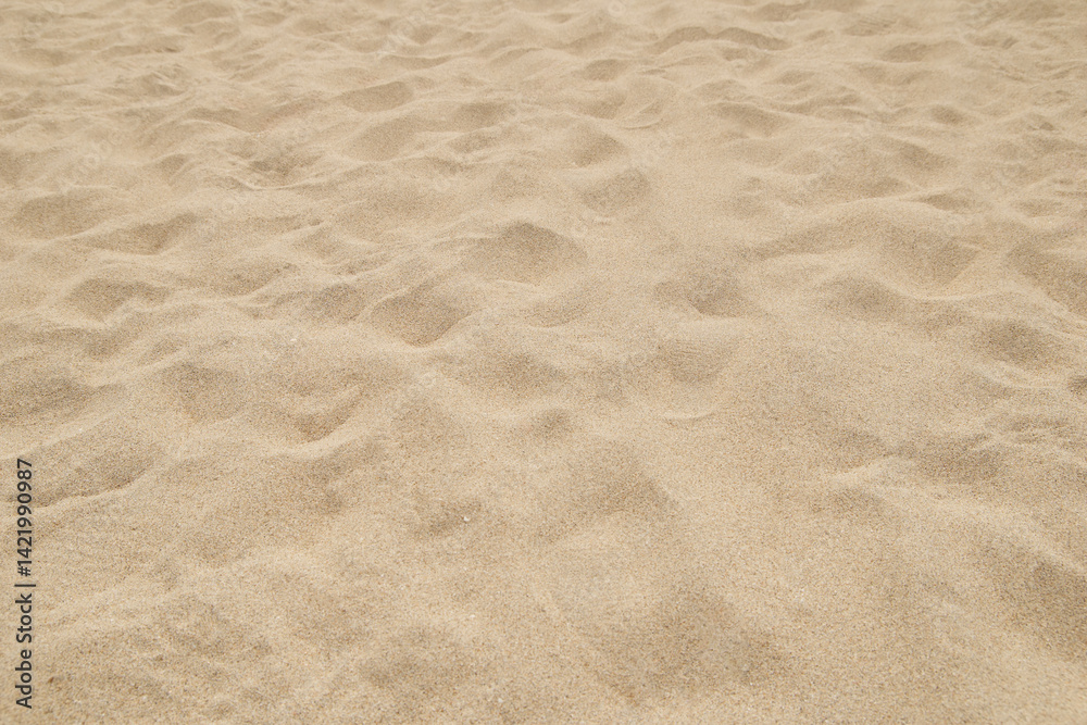 clean fine beach sand surface on bright sunny day, light beige or golden color soft and powdery particles, natural background of calming and natural beauty in soft focus