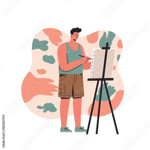 Young man painting on canvas with easel in casual outfit and artistic abstract background 