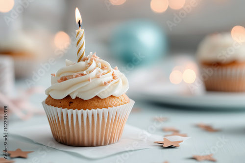 A single vanilla cupcake with smooth white frosting sits centered against a soft pastel background, such as pale peach or dusty blue