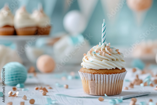 A single vanilla cupcake with smooth white frosting sits centered against a soft pastel background, such as pale peach or dusty blue