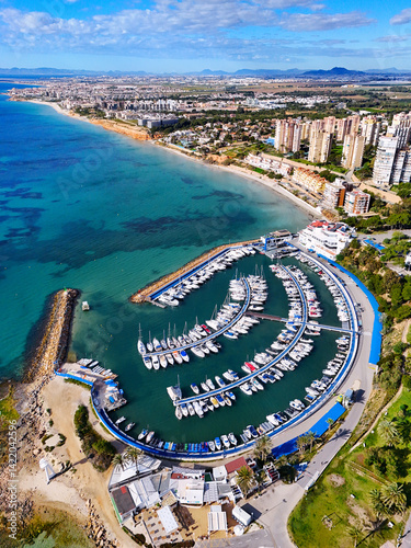 Obraz na płótnie Aerial view of Dehesa de Campoamor resort town, with marina, residential houses and bay of Mediterranean Sea. Province of Alicante, Spain. Costa Blanca w salonie